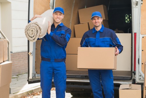 Removal van and moving team in Battersea residential street