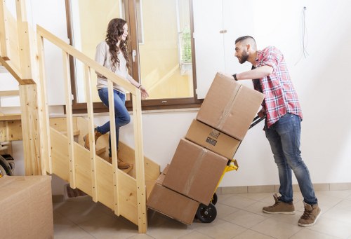 A moving van handling boxes and household items in Battersea
